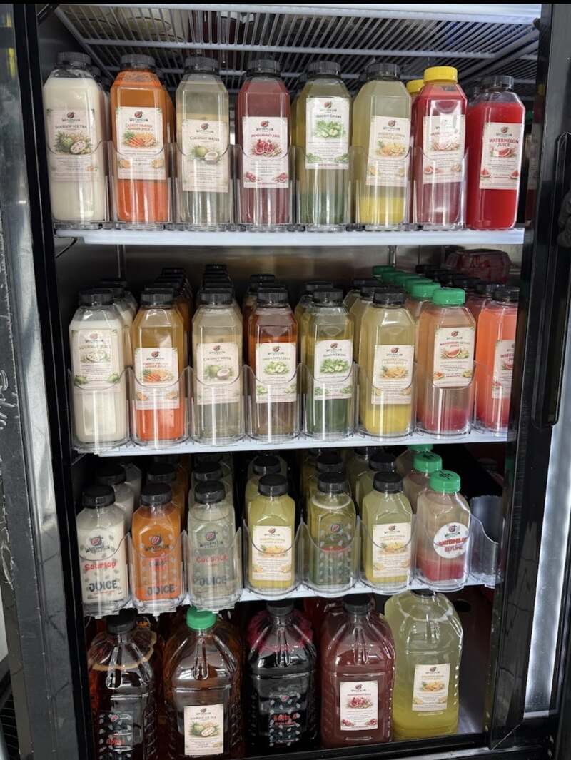The cooler stocked with cold pressed juices in every colour
